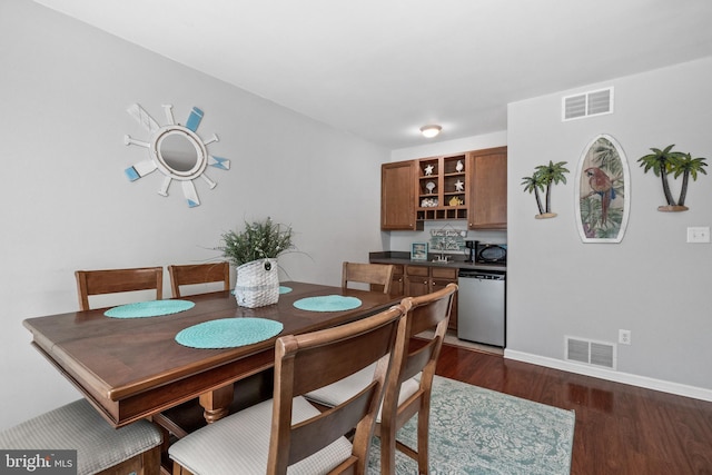 dining area with dark hardwood / wood-style floors