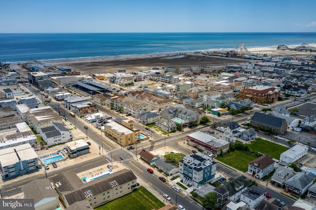 birds eye view of property featuring a water view and a view of the beach