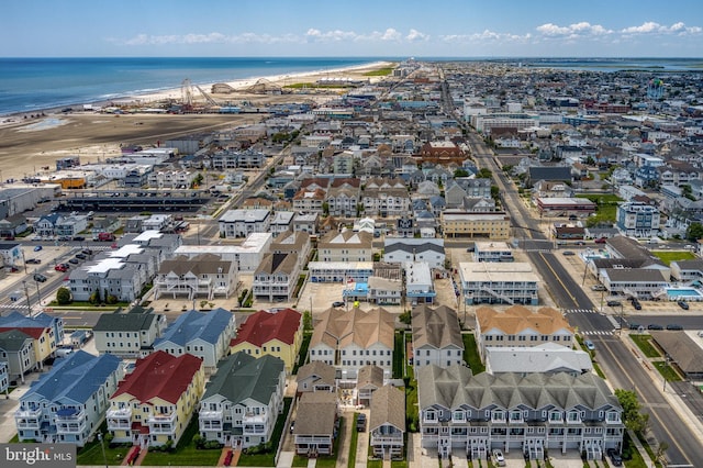 birds eye view of property with a beach view and a water view