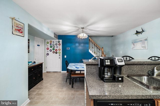 kitchen with dishwashing machine, sink, and a chandelier