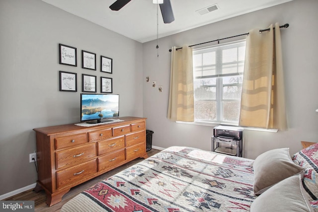 bedroom featuring ceiling fan and dark hardwood / wood-style flooring