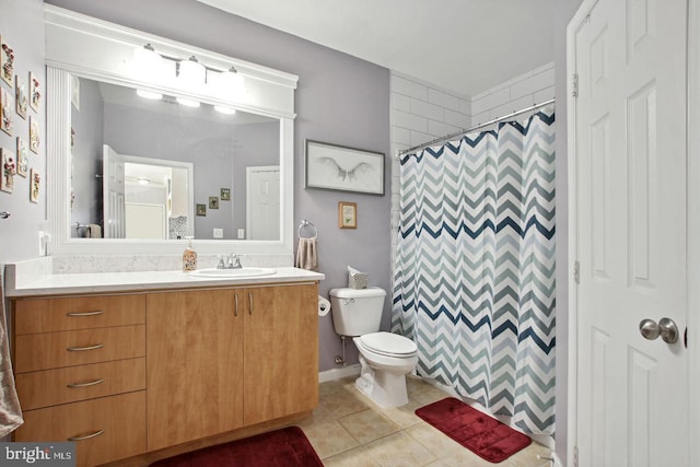 bathroom featuring vanity, walk in shower, tile patterned floors, and toilet