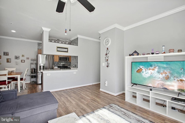 living room featuring crown molding, hardwood / wood-style flooring, and ceiling fan