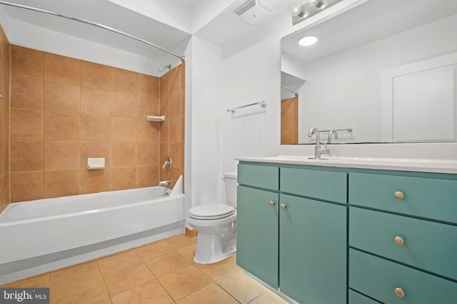 full bathroom with tiled shower / bath, toilet, tile patterned floors, and vanity