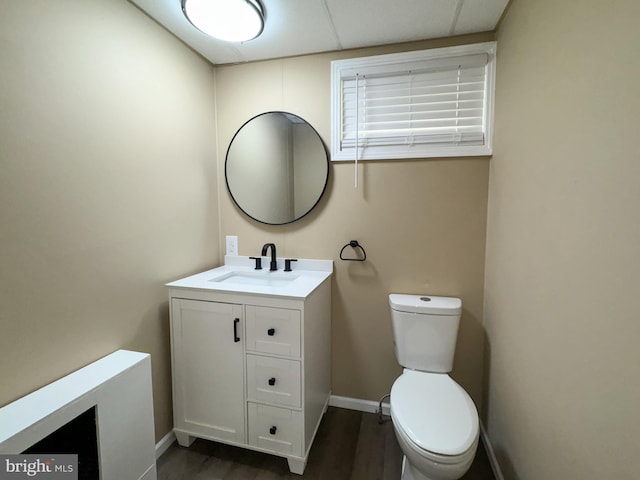 bathroom featuring hardwood / wood-style flooring, vanity, and toilet