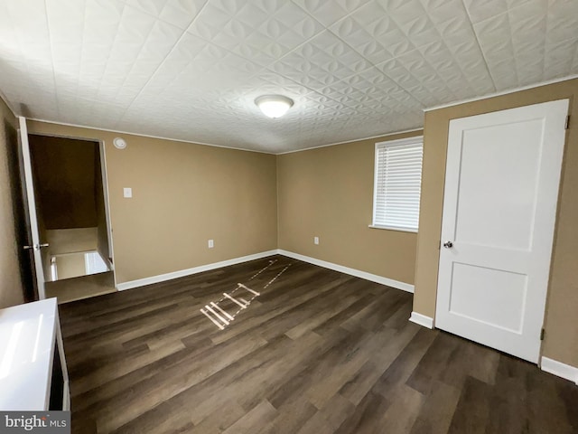unfurnished bedroom with dark hardwood / wood-style floors