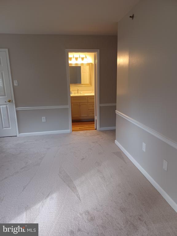 carpeted spare room with sink