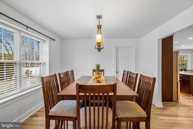 dining space featuring light wood-type flooring