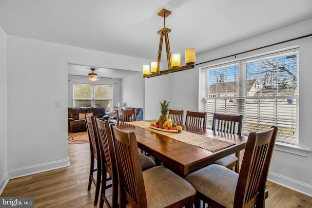 dining area featuring wood-type flooring and a notable chandelier