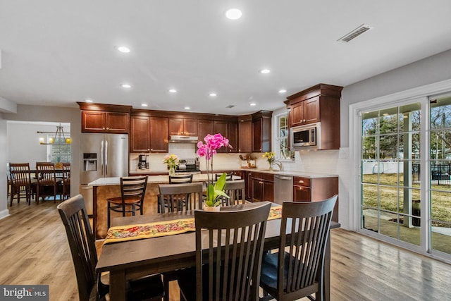 dining room with light hardwood / wood-style floors