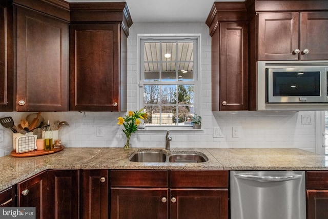 kitchen with tasteful backsplash, stainless steel appliances, and sink