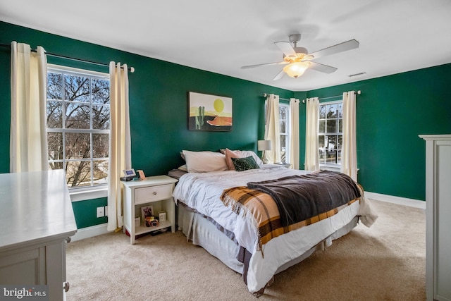 bedroom featuring light carpet and ceiling fan