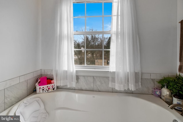 bathroom with a tub to relax in