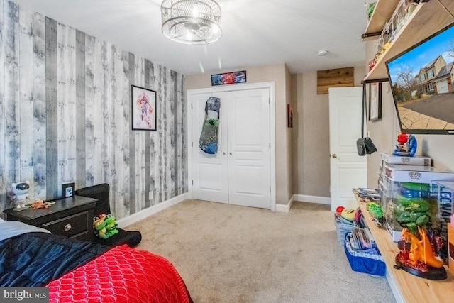 bedroom featuring a closet and light carpet