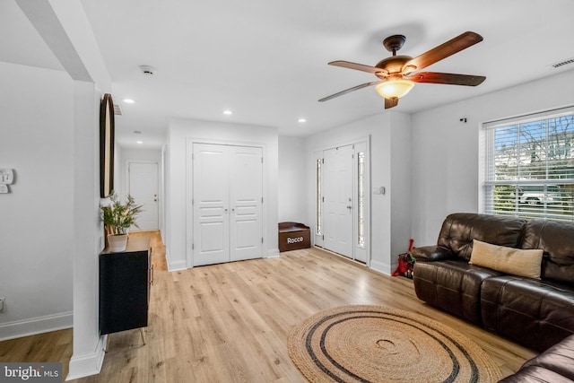 living room featuring ceiling fan and light wood-type flooring