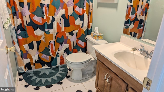 bathroom featuring tile patterned flooring, toilet, curtained shower, and vanity