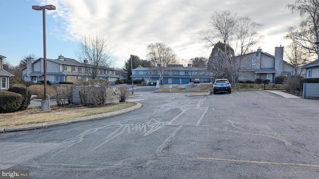 view of road with a residential view and curbs