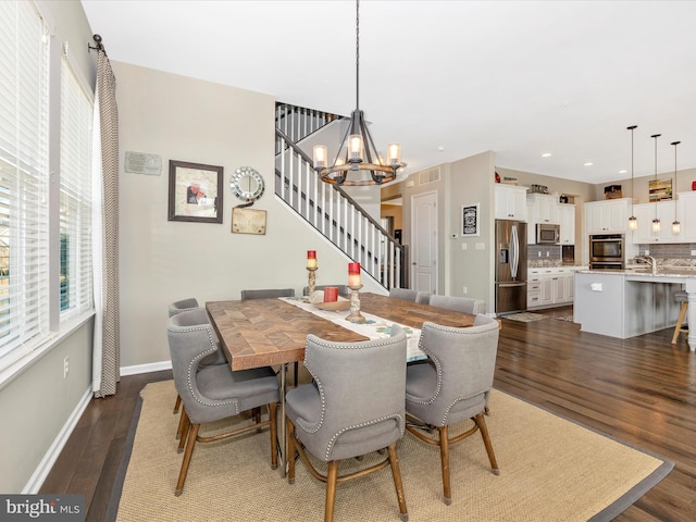 dining room with recessed lighting, a notable chandelier, dark wood-style flooring, baseboards, and stairs