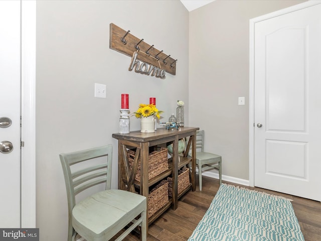 foyer entrance featuring dark wood-style floors and baseboards