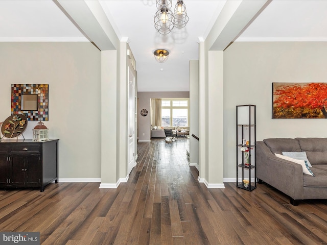 hallway featuring dark wood-type flooring, ornamental molding, and baseboards