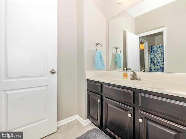 full bathroom featuring tile patterned flooring, vanity, and baseboards