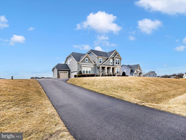 view of front of home featuring a garage, driveway, and a front yard