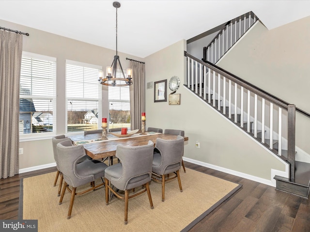 dining area featuring stairs, a chandelier, wood finished floors, and baseboards