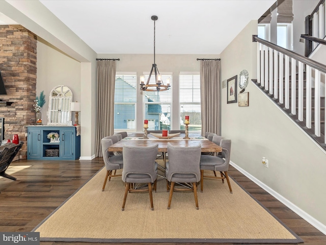 dining space with baseboards, stairway, a chandelier, and dark wood-type flooring