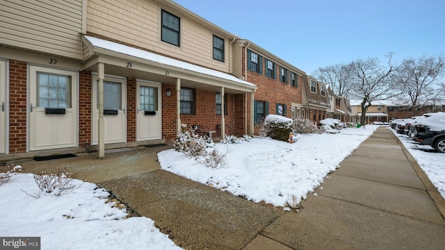 view of front of home with a residential view and brick siding