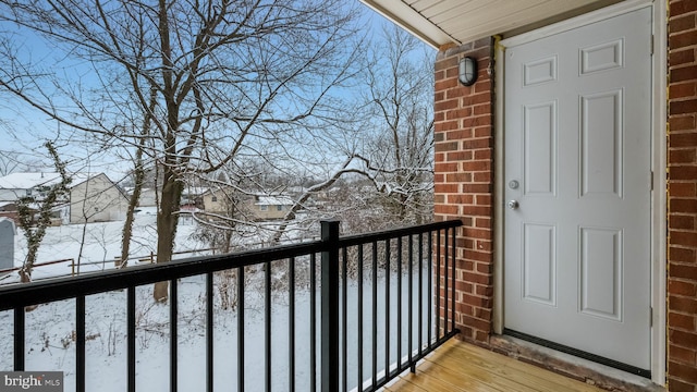 view of snow covered back of property