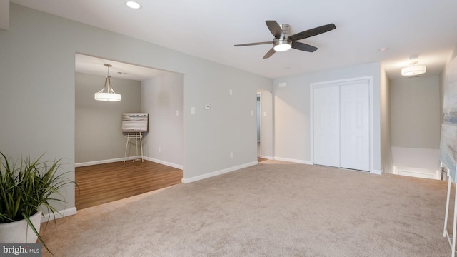 carpeted spare room with recessed lighting, baseboards, and ceiling fan