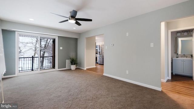 interior space with a sink, recessed lighting, baseboards, and ceiling fan