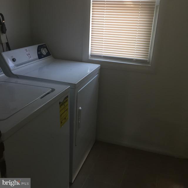 washroom with tile patterned flooring and separate washer and dryer