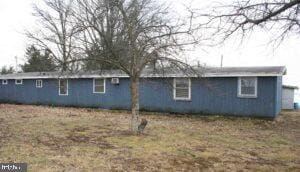 view of side of property with a lawn