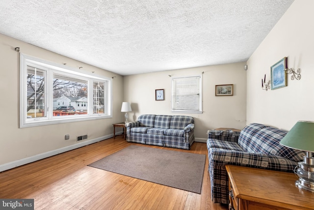 living room featuring hardwood / wood-style floors and a textured ceiling