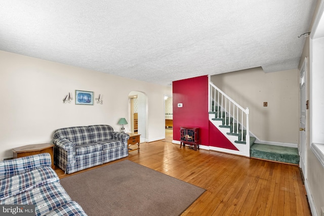 living room featuring hardwood / wood-style flooring and a textured ceiling