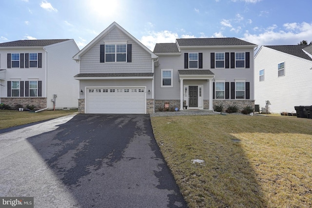 view of front of house featuring a garage and a front lawn