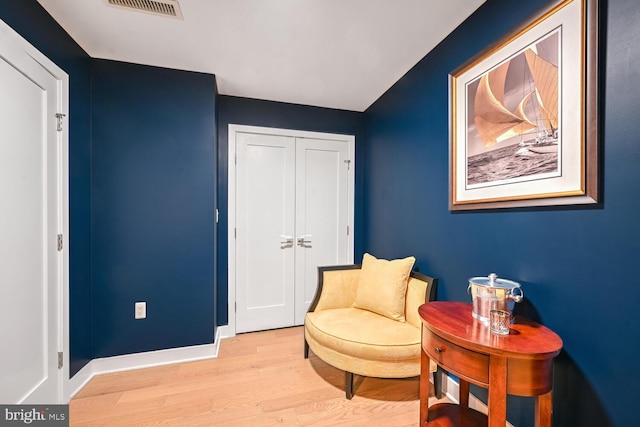 sitting room with light hardwood / wood-style flooring