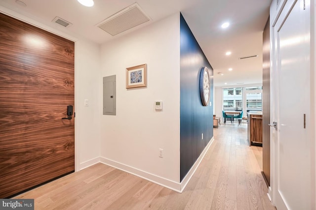 hall with electric panel and light hardwood / wood-style floors