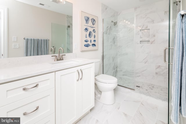 bathroom featuring vanity, toilet, and walk in shower