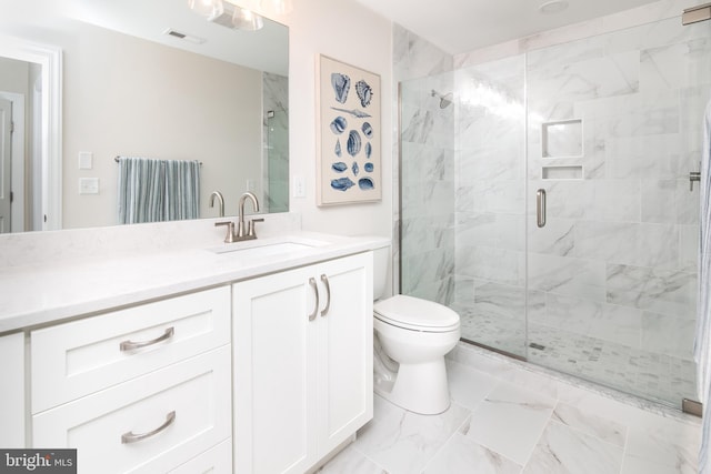 bathroom featuring vanity, toilet, and an enclosed shower