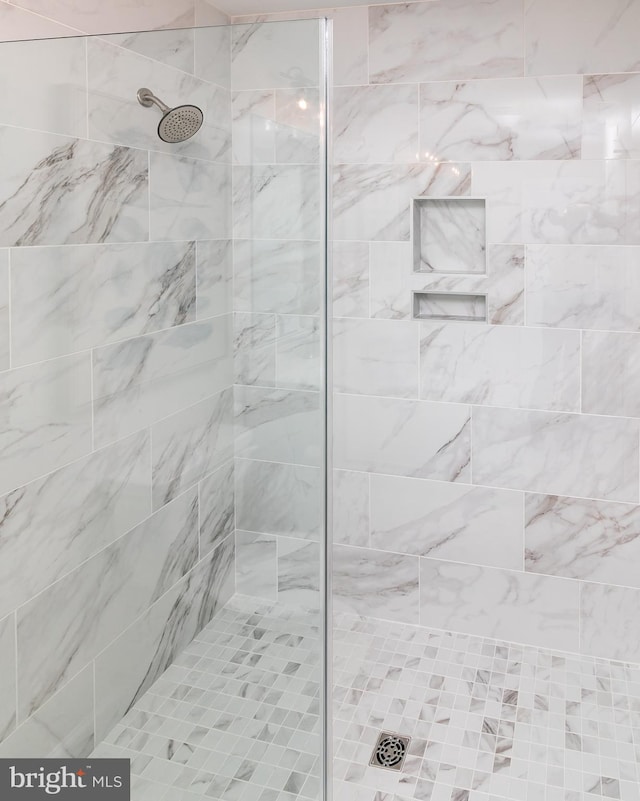 bathroom with a tile shower