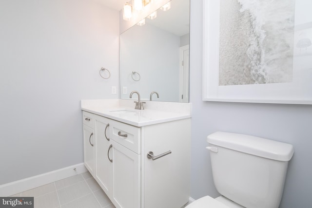 bathroom featuring vanity, toilet, and tile patterned flooring