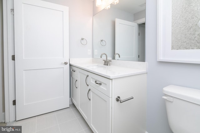 bathroom featuring vanity, toilet, and tile patterned flooring