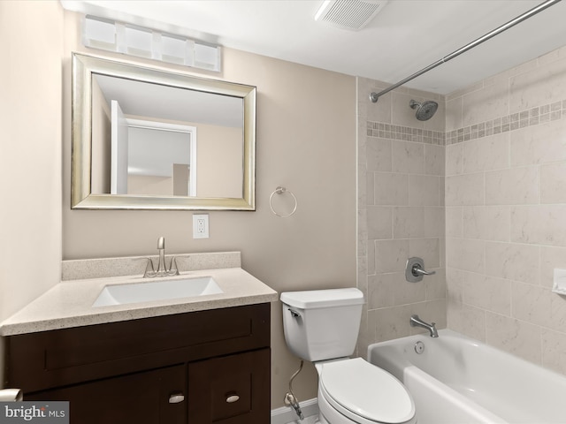 full bathroom featuring tiled shower / bath combo, vanity, and toilet