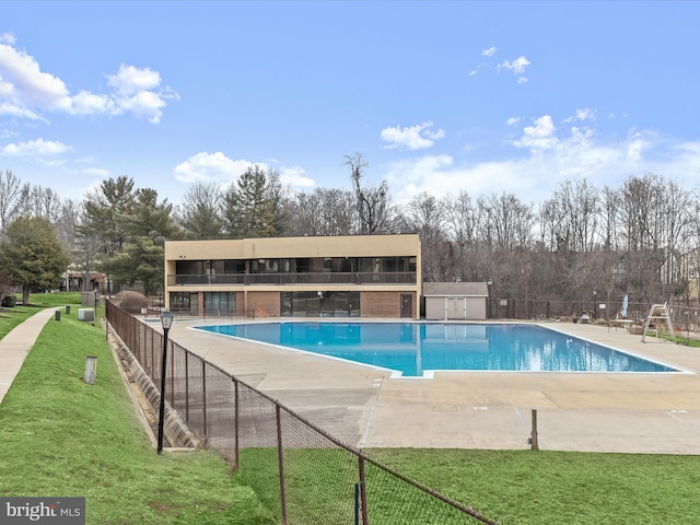 view of swimming pool with a patio area and a lawn