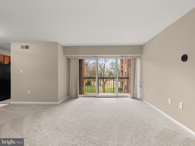 unfurnished living room featuring light colored carpet