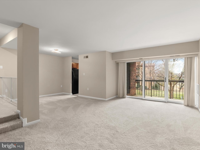 unfurnished room with light carpet