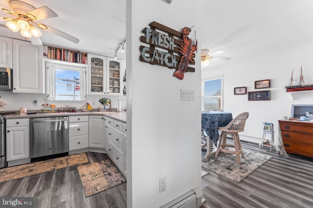 kitchen featuring dark hardwood / wood-style flooring, ceiling fan, white cabinets, and appliances with stainless steel finishes