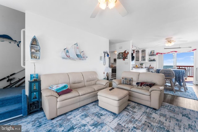 living room featuring ceiling fan and wood-type flooring